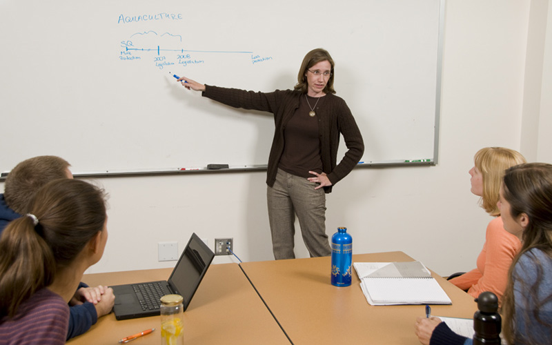 instructor in front of whiteboard